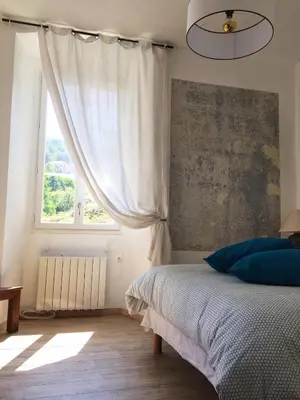 a bedroom with a bed and a window at Casa Mariana in Ghisoni