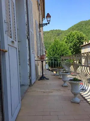 an open door of a building with vases on a sidewalk at Casa Mariana in Ghisoni