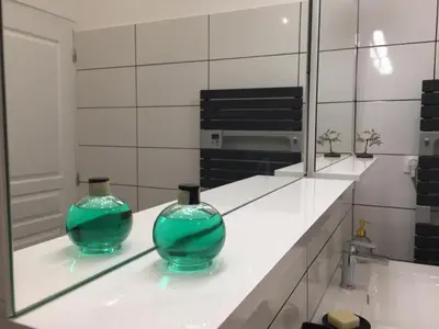 two green glass vases sitting on a counter in a bathroom at Casa Mariana in Ghisoni