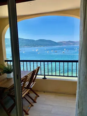 a balcony with a view of the ocean and boats at Studio 3 personnes Front de Mer in Tiuccia