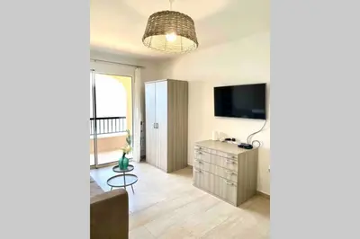 a living room with a television and a dresser at Studio 3 personnes Front de Mer in Tiuccia