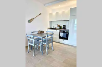 a kitchen with a table and chairs in a room at Studio 3 personnes Front de Mer in Tiuccia
