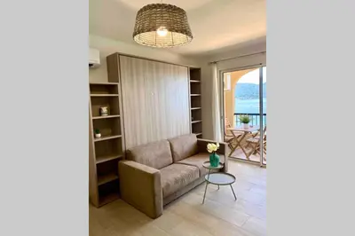 a living room with a couch and a table at Studio 3 personnes Front de Mer in Tiuccia