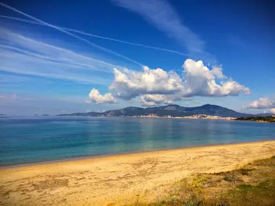 a beach with a view of the ocean and mountains at Grand T2 STANDING AJACCIO Proche centre et plages VUE PANORAMIQUE PARKING PRIVE in Ajaccio