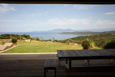 a patio with a table and a view of the water at Villa BARQUIERO in Coti-Chiavari