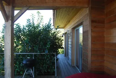 an outside porch of a house with a plant at Villa BARQUIERO in Coti-Chiavari