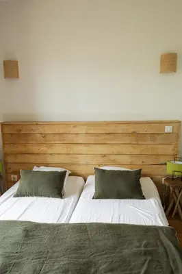 a large bed with two pillows in a bedroom at Villa BARQUIERO in Coti-Chiavari
