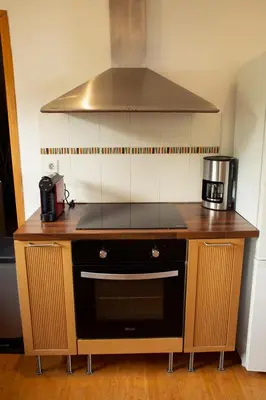 a kitchen with a stove and a microwave at Villa BARQUIERO in Coti-Chiavari