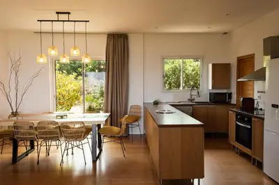 a kitchen and dining room with a table and chairs at Villa BARQUIERO in Coti-Chiavari