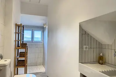 a bathroom with a ladder next to a toilet at Cargèse, appartement de charme surplombant le port in Cargèse