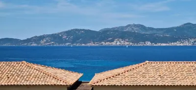 a view of a large body of water with mountains at Appartement vue mer panoramique près de Porticcio in Pietrosella