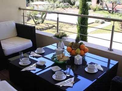a table with a bowl of fruit on a balcony at Nature & Design in Bonifacio