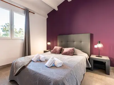 a bedroom with a large bed with purple walls at Holiday Home Pietralunga-1 by Interhome in Sotta