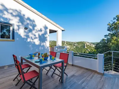 a table and chairs on the balcony of a house at Holiday Home Pietralunga-1 by Interhome in Sotta