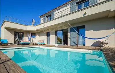 a swimming pool in front of a house at 3 Bedroom Awesome Home In Calenzana in Calenzana