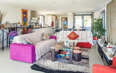 a living room with a couch and a table at 3 Bedroom Awesome Home In Calenzana in Calenzana