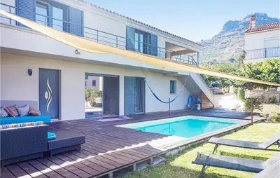 a house with a swimming pool in the backyard at 3 Bedroom Awesome Home In Calenzana in Calenzana