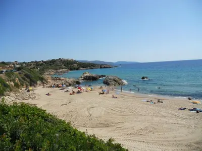 a group of people on a beach with the ocean at Gites-Sassone in Sagone