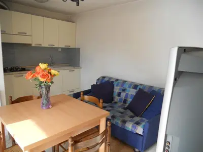 a living room with a table with a vase of flowers on it at Gites-Sassone in Sagone