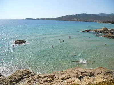a group of people in the water at a beach at Gites-Sassone in Sagone
