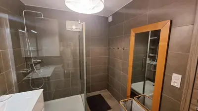a bathroom with a shower with a glass door at Appartement neuf T2 centre de Porticcio in Porticcio