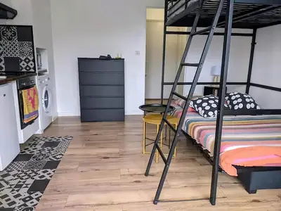 a bedroom with a bunk bed and a kitchen at Studio 4 pers terrasse vue mer in Ajaccio