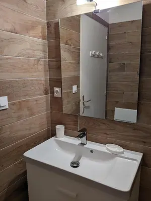 a bathroom with a white sink and a mirror at Studio 4 pers terrasse vue mer in Ajaccio