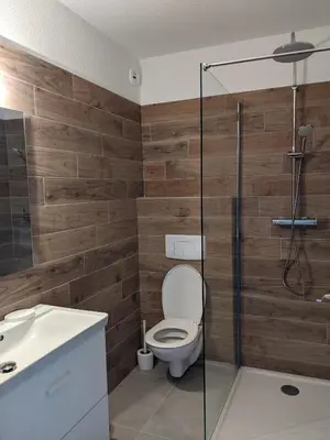 a bathroom with a toilet and a glass shower at Studio 4 pers terrasse vue mer in Ajaccio