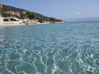a body of water with a beach in the background at Studio 4 pers terrasse vue mer in Ajaccio