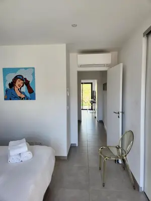 a kitchen with a counter with white cabinets at Villa HOME HOLIDAY à Cala Rossa in Lecci