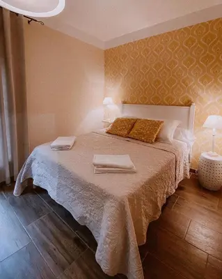a bedroom with a bed with two towels on it at Auberge De La Foret Bonifatu in Calenzana