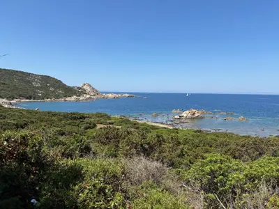 a view of a beach with the ocean in the background at Appartement de charme entre mer et montagne in Sollacaro