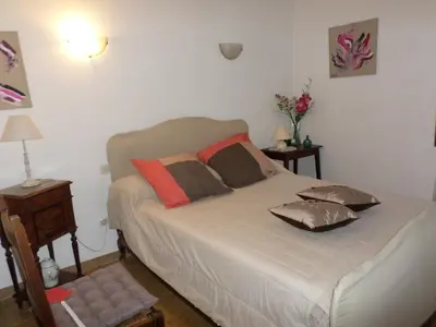 a bed with pillows on it in a bedroom at Maison de charme proche mer en Corse du Sud in Sollacaro