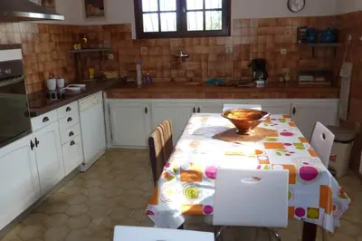 a kitchen with a table with a bowl on it at Maison de charme proche mer en Corse du Sud in Sollacaro