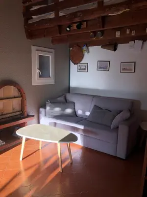 a living room with a couch and a table at A Pineta in Porticcio