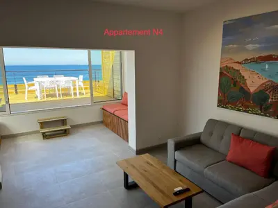 a living room with a couch and a table at Appartements résidence Harmonie vue mer in Porticcio