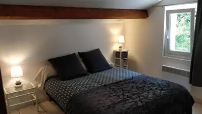 a bedroom with a bed with two pillows and a window at Casetta in Ortiporio