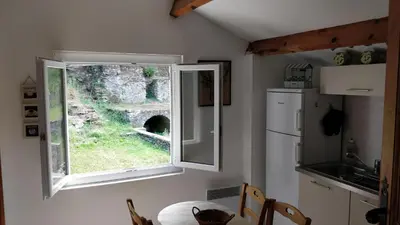 a kitchen with a window in a kitchen with a table at Casetta in Ortiporio