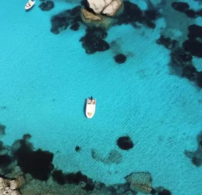 an aerial view of a boat in the water at Villa Santa Giulia in Porto-Vecchio
