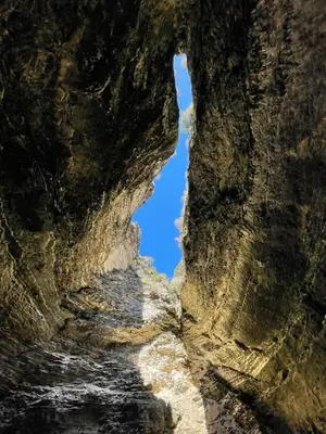 a cave in the rocks with a blue sky in the background at Villa Santa Giulia in Porto-Vecchio