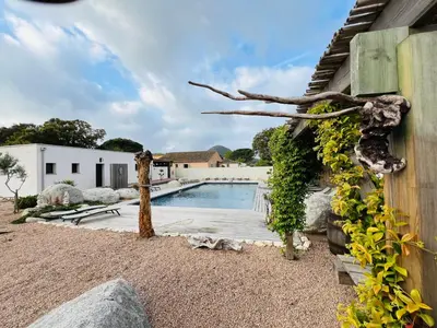 a swimming pool in the backyard of a house at Villa Santa Giulia in Porto-Vecchio