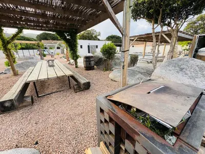 a picnic table and a bench in a yard at Villa Santa Giulia in Porto-Vecchio