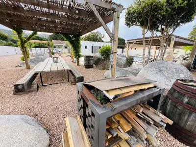 a picnic table and a bench and a barrel at Villa Santa Giulia in Porto-Vecchio