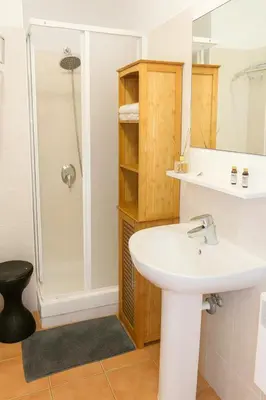 a bathroom with a sink and a shower at Moriani-Plage : Résidence en bord de mer in San-Nicolao