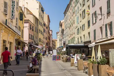 a city street with people walking down a street with buildings at studio cosy centre ville in Ajaccio