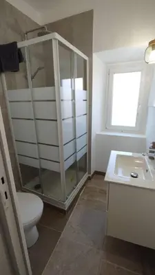a bathroom with a shower and a toilet and a sink at studio cosy centre ville in Ajaccio