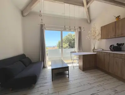 a living room with a couch and a table at Joli F1 en bordure d'Ajaccio in Ajaccio