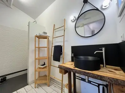 a bathroom with a sink and a mirror on the wall at Joli F1 en bordure d'Ajaccio in Ajaccio