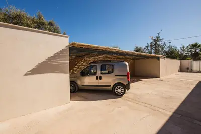 a small van is parked in a garage at Petra d'Oro Villa Palombaggia in Porto-Vecchio