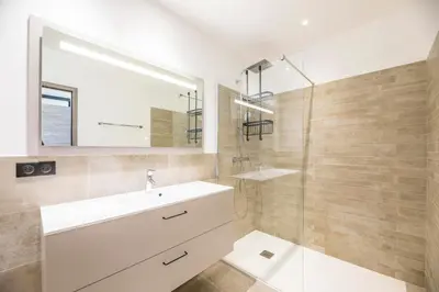 a bathroom with a white sink and a shower at Villa 20 in Sainte-Lucie de Porto-Vecchio